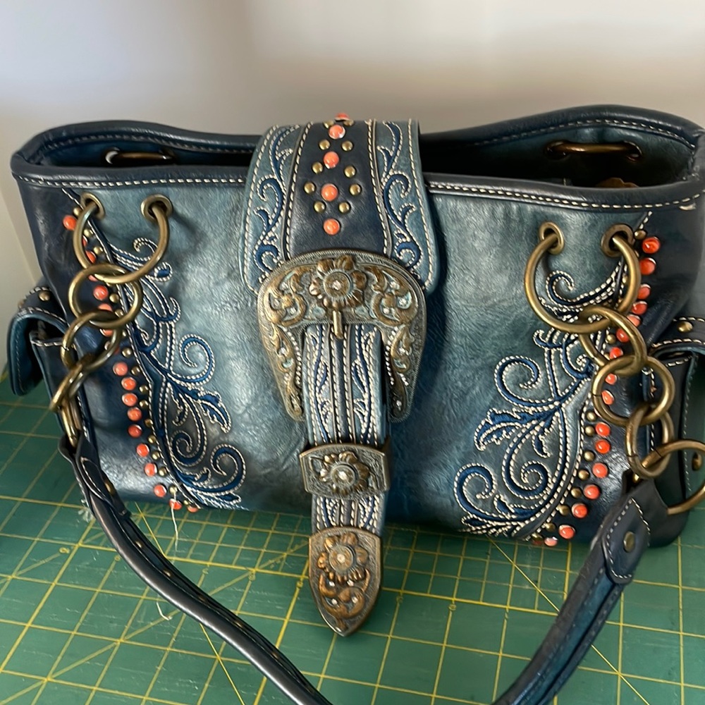 This is a western shoulder bag made of leather